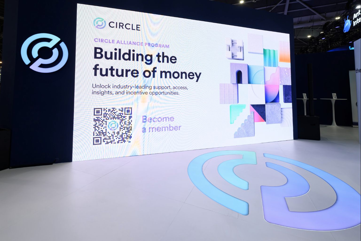 The Circle stand's LED wall carrying the Circle Alliance Program, the brand mark inlaid in the floor beside it