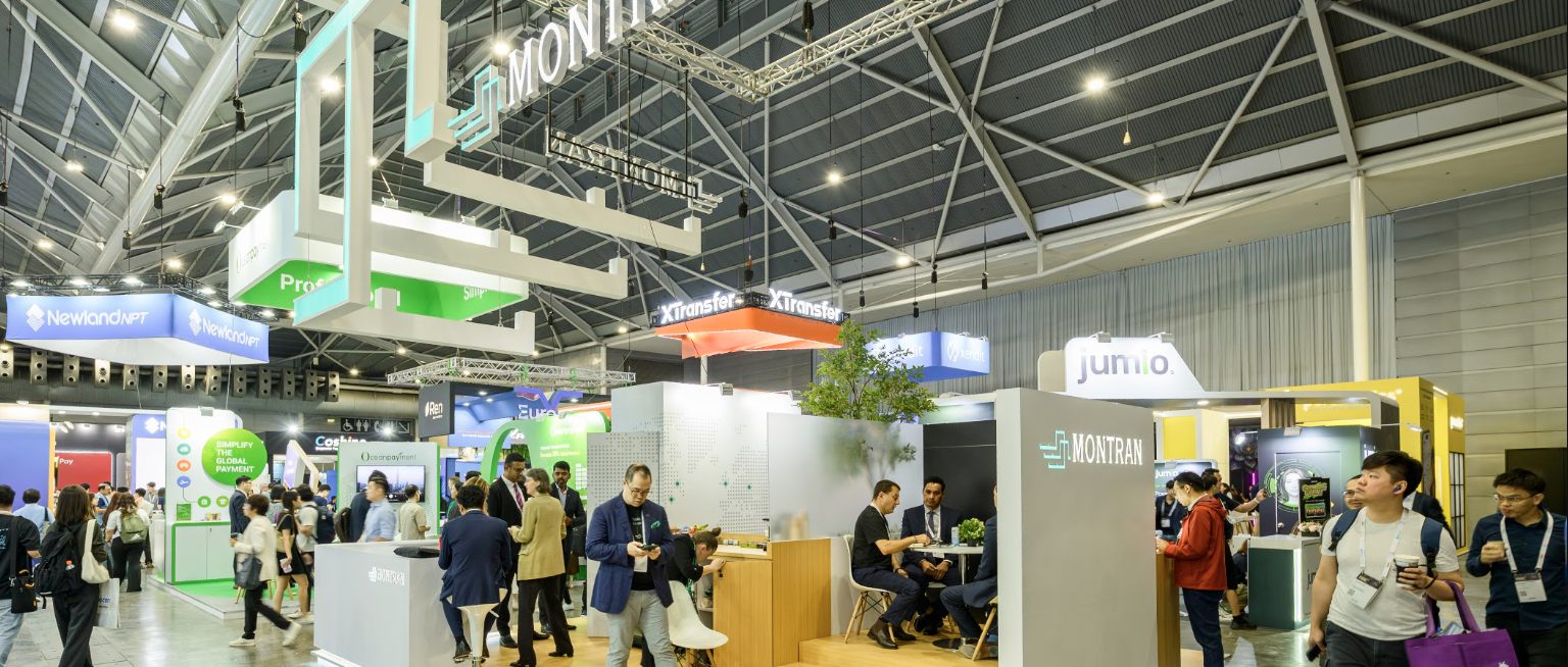 The Montran stand seen across the Singapore FinTech Festival hall, its suspended structure held above the aisle