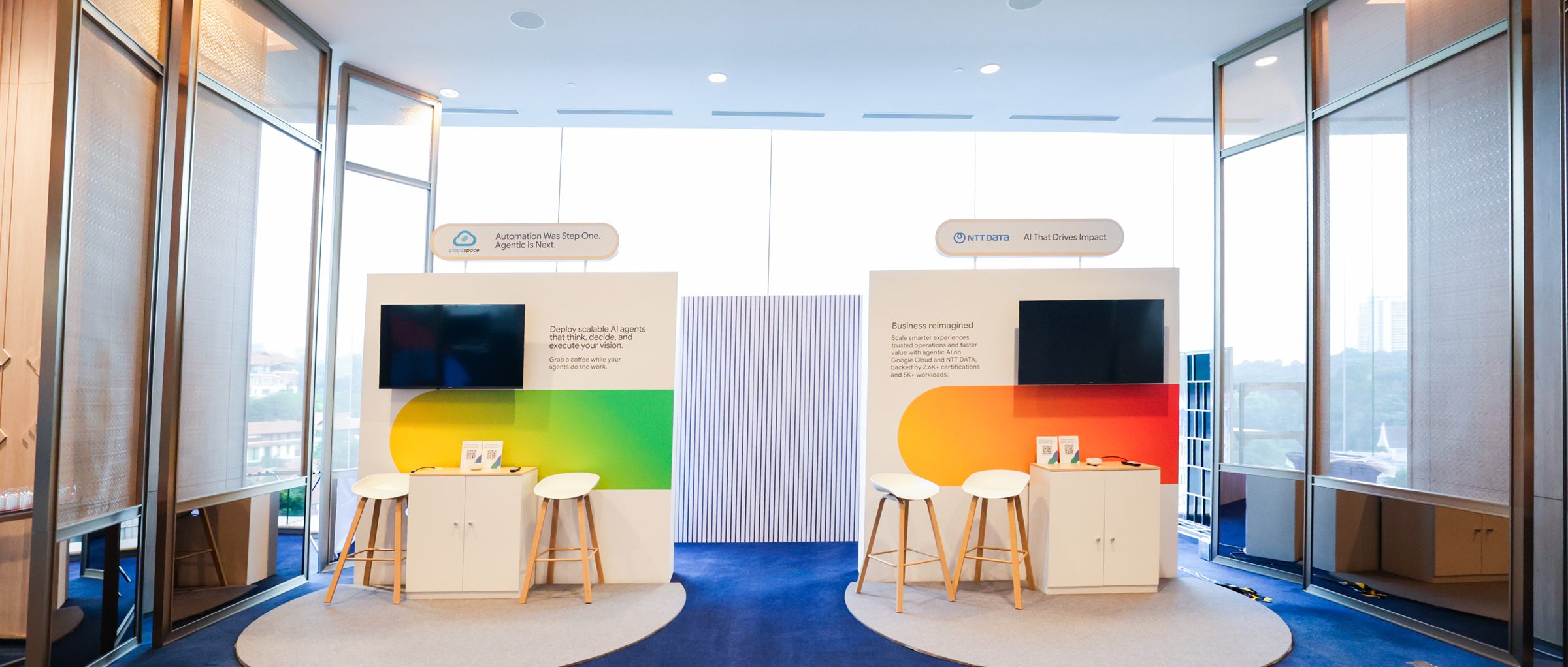 Two sponsor pods built out symmetrically against floor-to-ceiling windows before doors open