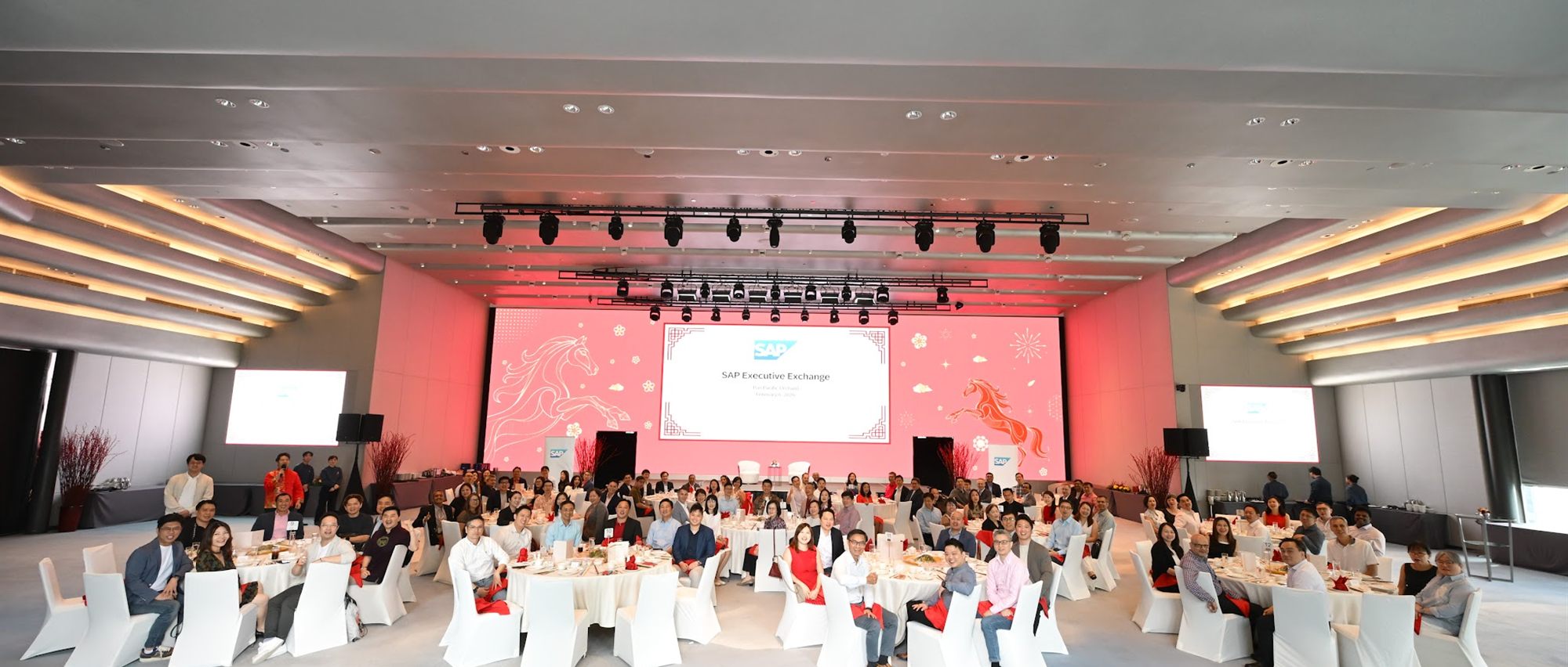 The SAP Executive Exchange gala dinner, guests seated at rounds facing a Year of the Horse stage backdrop